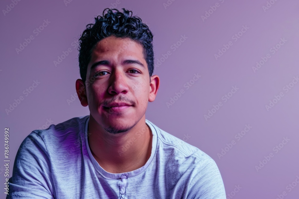 Portrait of young asian man looking at camera on purple background Portrait of young asian man looking at camera on purple background