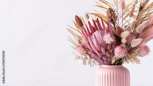 Beautiful dried flower arrangement in a stylish pink vase. In the flower bunch is pink King Proteas,