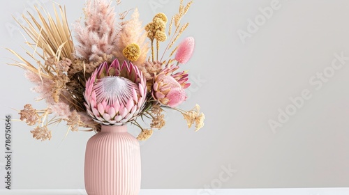 Beautiful dried flower arrangement in a stylish pink vase. In the flower bunch is pink King Proteas,