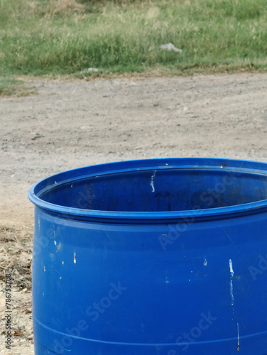 blue plastic barrel for water in a park