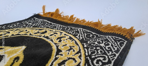 Muslim prayer mat on white background photo