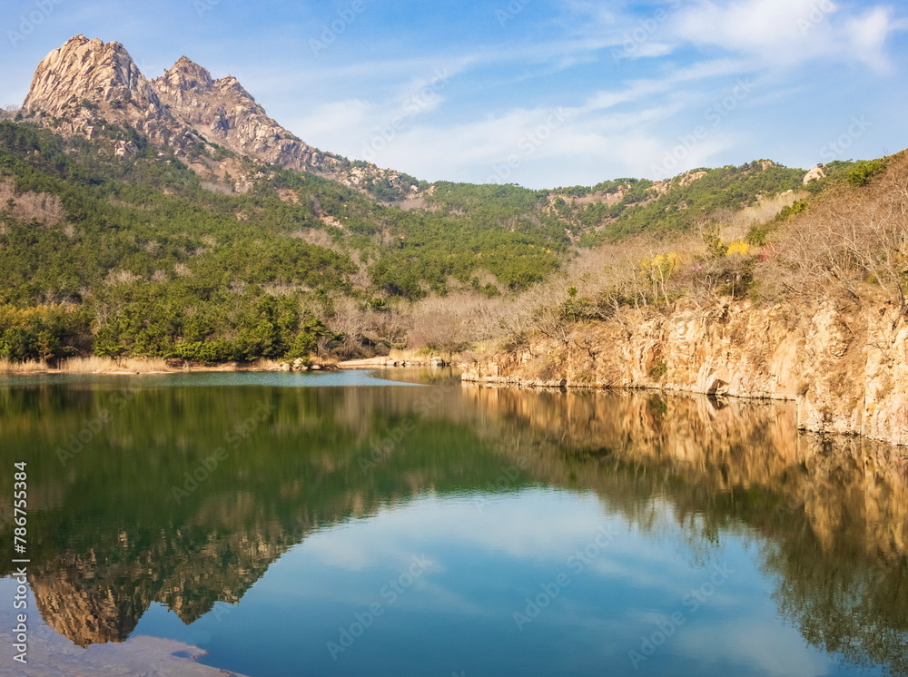 Reflection of mountains in the lake. Spring in Qingdao. Landscape of Fushan Eco-Park. Qingdao. China.