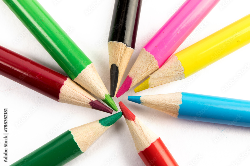 macro close up of sharp colorful pencil crayon tips arranged in a star isolated on white macro close up of sharp colorful pencil crayon tips arranged in a star isolated on white