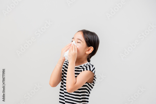 Little asian kid girl with allergy sneezing