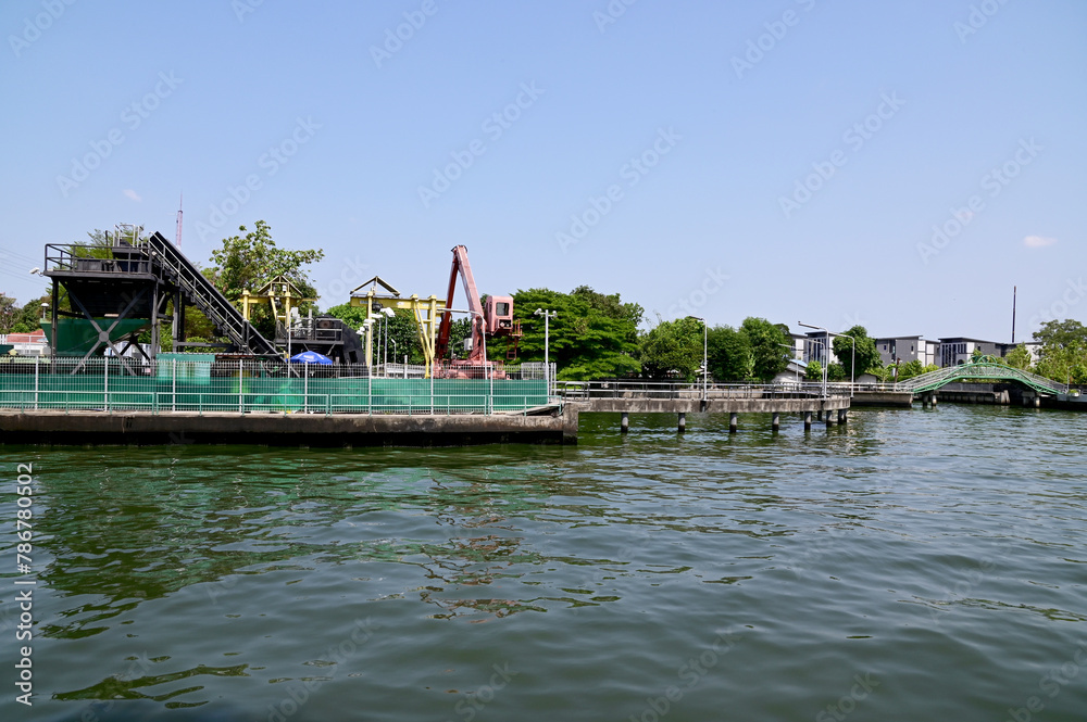 BANGKOK, THAILAND - April 17, 2024: crane for picking up garbage with waste sorting machines in Saen Saeb Canal at Khlong Kacha Pump Station in Thailand.