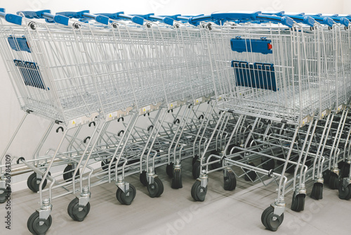 Rows of shopping carts on car park near entrance. row of empty shopping carts in the supermarket. 