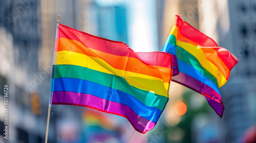 Pride month and inclusivity, support of LGBTQ. LGBT rainbow flags being waved in the air at a pride event. Wave LGBTQ gay pride flags. Equality Parade. Pride rainbow LGBTQ gay flag being waved 