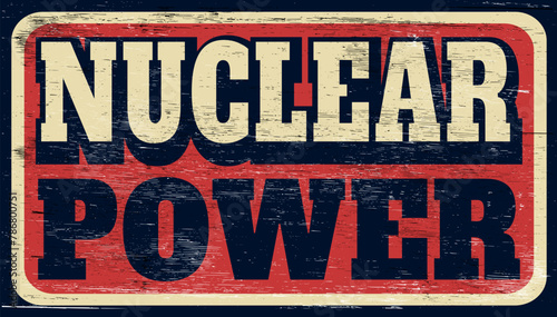 Aged and worn nuclear power sign on wood