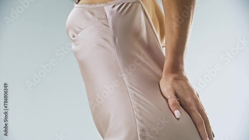 Girl gently runs her hand over her curves, touching the light underwear as she moves from her legs to her hips and waist. Close up. Slow motion. 4k