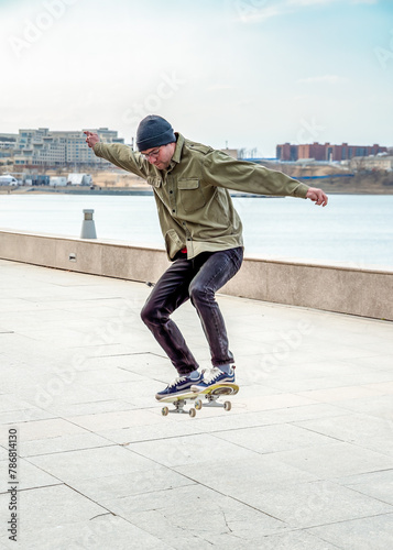 Young man riding a skateboard making tricks and jumps