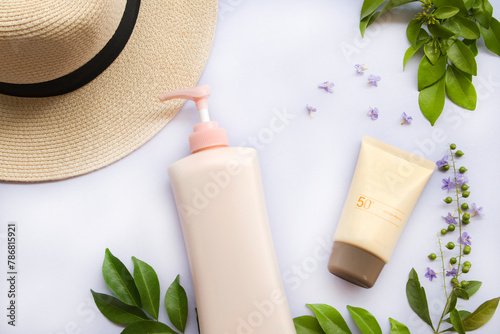 sunscreen spf50, body lotion and hat of lifestyle woman relax summer arrangement flat lay style on background white