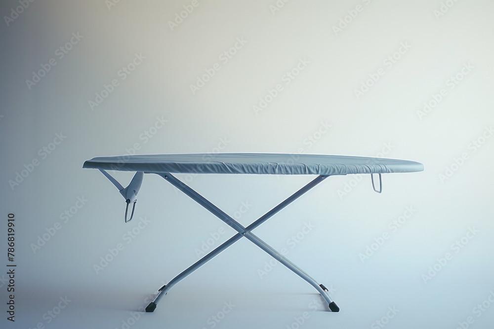 Simple Collapsible Ironing Board with Striped Cover Ready for Household Chores Against Soft Light Simple Collapsible Ironing Board with Striped Cover Ready for Household Chores Against Soft Light