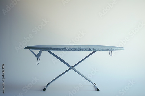 Simple Collapsible Ironing Board with Striped Cover Ready for Household Chores Against Soft Light photo