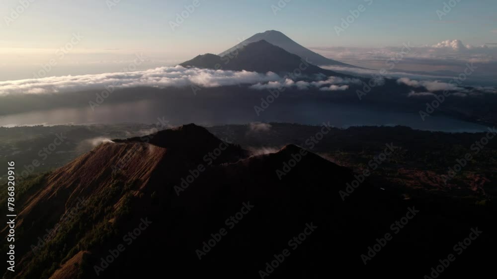 Mount Abang From Mount Batur Volcano At Sunrise In Bali, Indonesia. - aerial shot Mount Abang From Mount Batur Volcano At Sunrise In Bali, Indonesia. - aerial shot