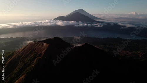 Mount Abang From Mount Batur Volcano At Sunrise In Bali, Indonesia. - aerial shot photo