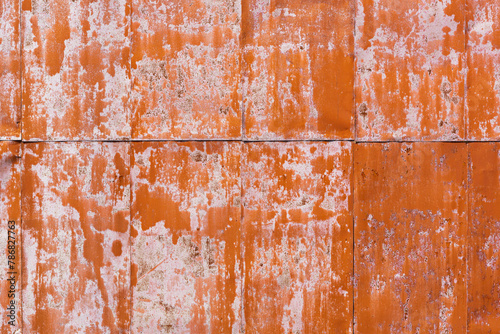 rusty metal sheet painted red. shabby background of industrial building wall.