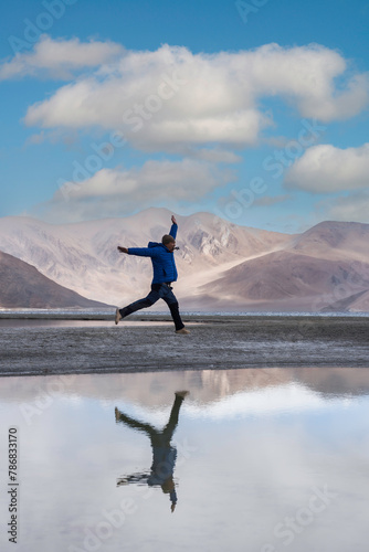 Male tourist standing and Traveler man enjoy Pangong Lake Merak, Leh, Jammu and Kashmir ,India.
