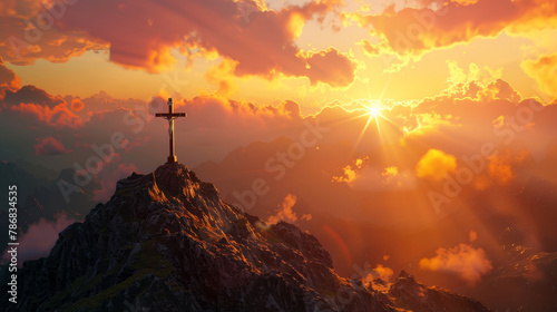 A mountain with a cross on top and a sunset in the background