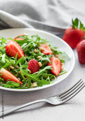 Fresh Strawberry Arugula Salad With Pine Nuts Served on a Bright Day