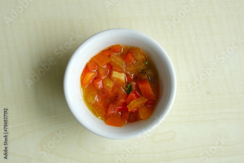 Dabu-dabu sauce in bowl, this is a type of culinary condiment that can generally be found in Manado cuisine from North Sulawesi, Indonesia.  photo