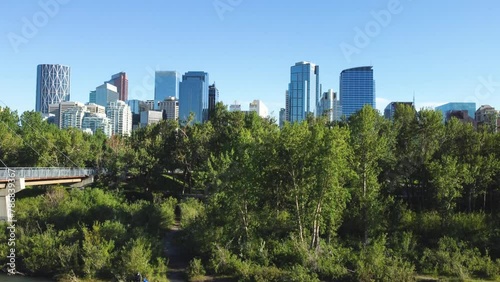 Downtown Calgary, Alberta, Canada skyline. Wide aerial drone view, from the Bow River on a sunny blue skies day. Prince Island Park. photo