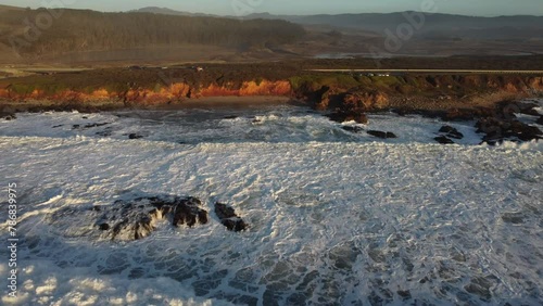 Aerial Drone Zoom In of coast of Pescadero State Beach during Sunset photo