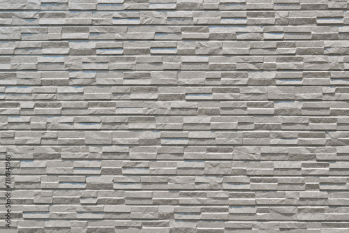Exterior wall tiles of a building with a texture that appears quite hard