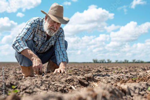 A farmer gazing sadly at wilted crops in a barren field, showcasing the impact of the drought on agriculture.