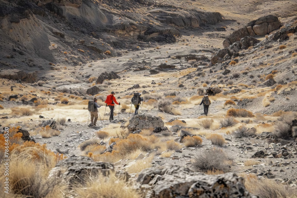 A group of hikers trekking through a dry, rocky landscape, searching for water sources during the drought.