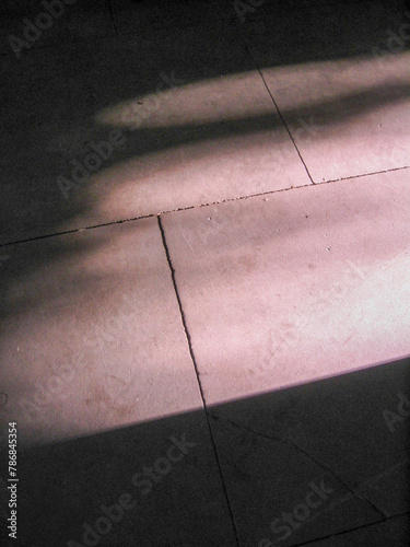 light from a doorway striking flagstone floor