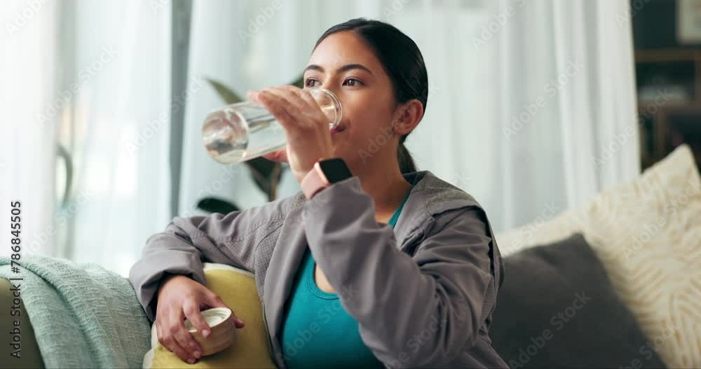 Living room, woman and drinking water in bottle for fitness, natural nutrition or break in exercise. Athlete, hydration and organic liquid on sofa for healthy diet, detox and workout training at home Living room, woman and drinking water in bottle for fitness, natural nutrition or break in exercise. Athlete, hydration and organic liquid on sofa for healthy diet, detox and workout training at home