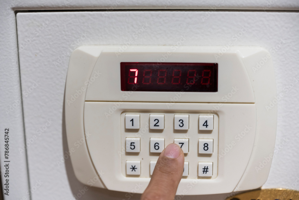 Close up code lock on the safe door.Safe for customer in hotel room.Press key on safety lock number.Safety and security concept. Close up code lock on the safe door.Safe for customer in hotel room.Press key on safety lock number.Safety and security concept.