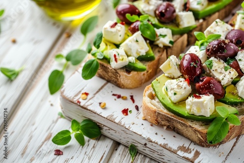 Close-up vegetarian open sandwich with avocado and feta on wooden table, healthy meal option
