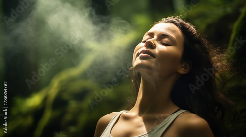  a relaxed woman breathing fresh air in a green forest. Young woman breathing pure air in a forest