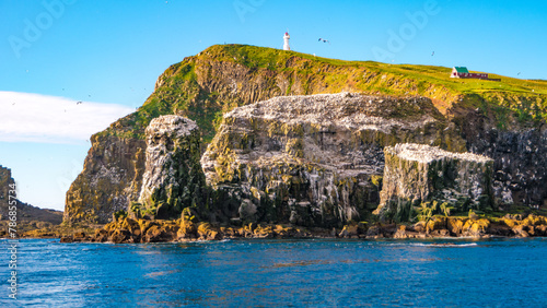 Mykines, Faroe Islands. Panoramic view of Mykines island, bird watching destination for puffins. Lighthouse at fjords landscape and seascape photo