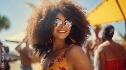 stylish Black woman smiling at a summer beach party.