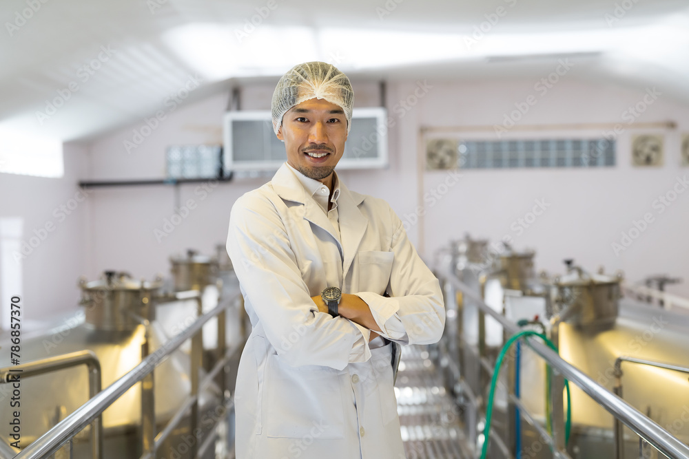 Male factory winemaker inspecting quality during manufacturing in process in fermentation wine factory. Wine manufacturing industry concept Male factory winemaker inspecting quality during manufacturing in process in fermentation wine factory. Wine manufacturing industry concept