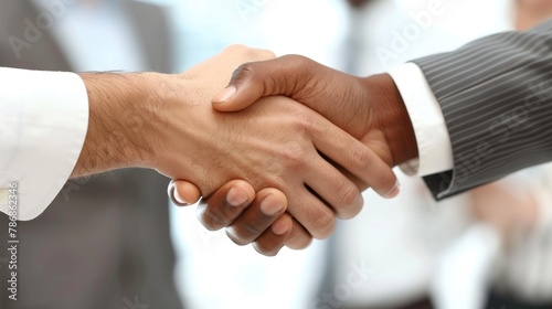 A close-up of diverse businesspeople shaking hands in a gesture of partnership and agreement.