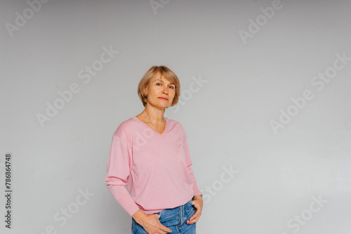 Beautiful stylish adult woman in a pink sweater looking confident relaxed and happy healthy woman 