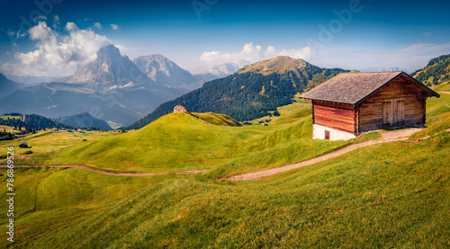 Sunny summer view of Sassolungo (Langkofel) mountain range in Dolomites National Park, South Tyrol, Italy, Europe. Wonderful morning scene of Gardena valley. Travel the world.. photo
