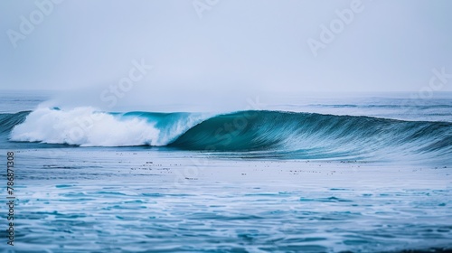 A large wave in the ocean with a white crest and a blue-green body. photo