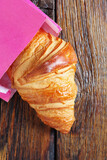 Croissant in a pink bag