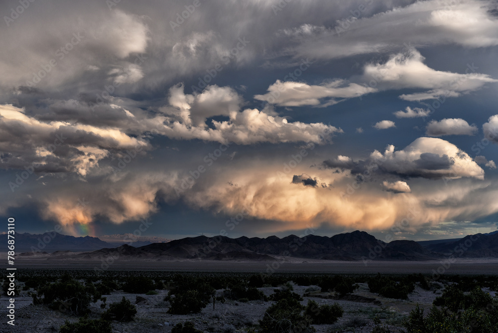 Dramatic sky with Rainbow near Dumont Dunes along Route 127 in the Mojave Desert, California Dramatic sky with Rainbow near Dumont Dunes along Route 127 in the Mojave Desert, California