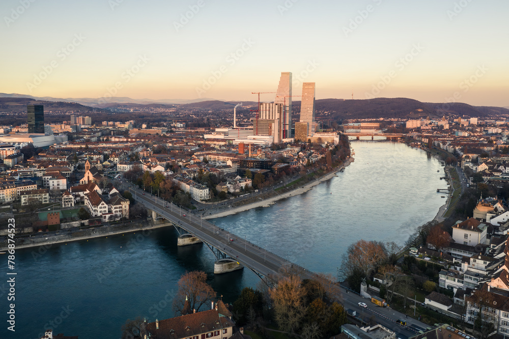 Basel, Switzerland: Aerial view of the twilight over Basel old town and office tower along the Rhine river in Switzerland