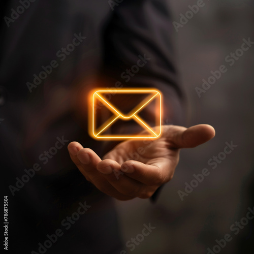 Businessman is holding virtual email symbol, message icon