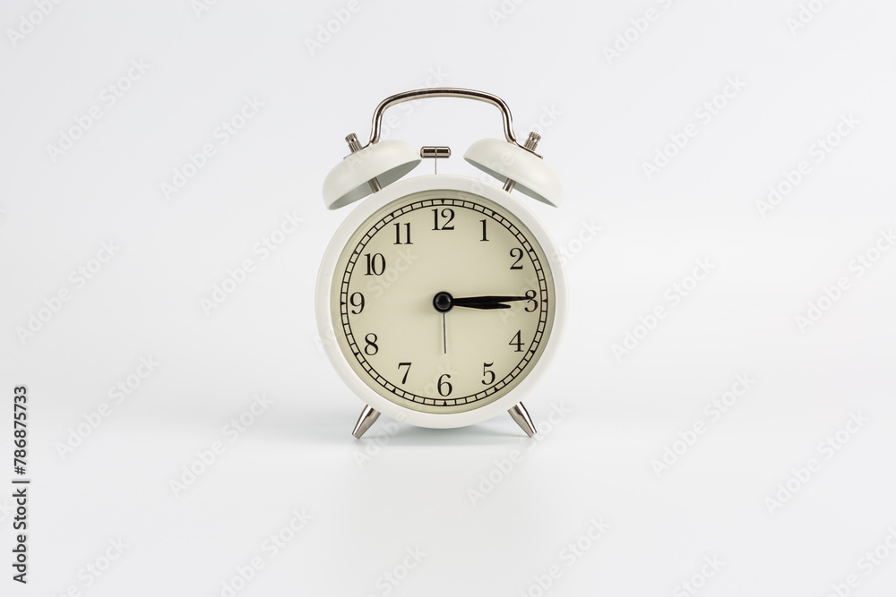 Retro white clock on a white background, the hands show the time at 15:15 or 3:15 AM or 3:15 PM Retro white clock on a white background, the hands show the time at 15:15 or 3:15 AM or 3:15 PM