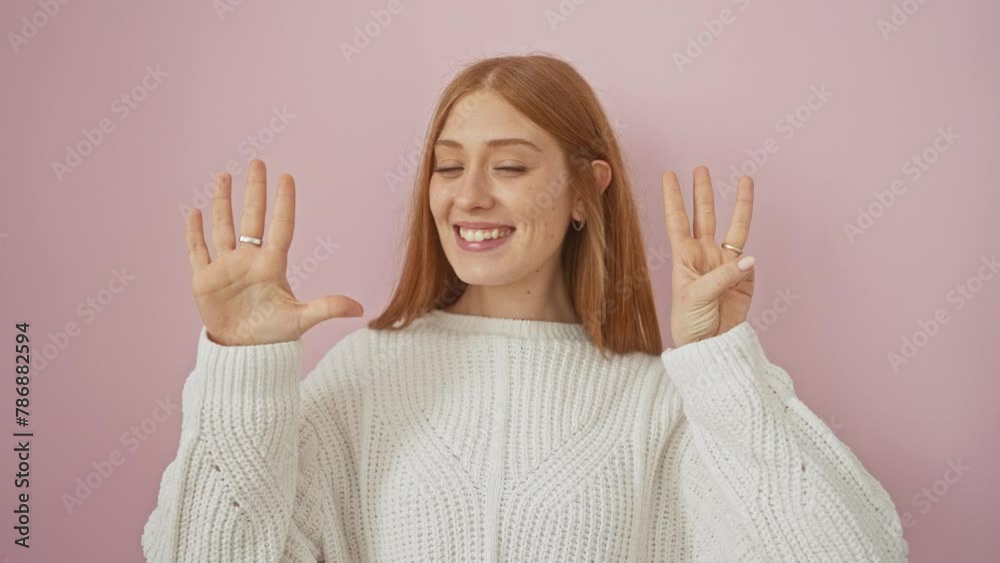 Gleaming young redhead woman in sweater gleefully showing off the number eight with fingers, standing proud over pink isolated background. Gleaming young redhead woman in sweater gleefully showing off the number eight with fingers, standing proud over pink isolated background.