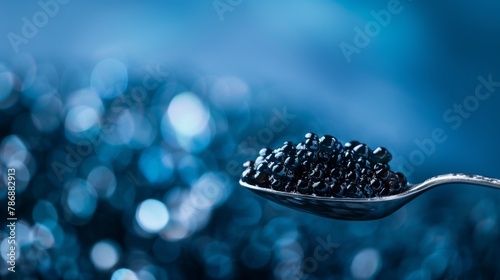 Luxurious caviar on a motherofpearl spoon, against a deep sea blue, soft lighting for a sophisticated feel photo