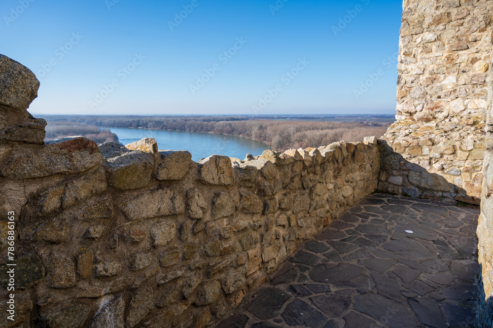 Part of Devin Castle in Bratislava with view of Danube River in autumn forest.
