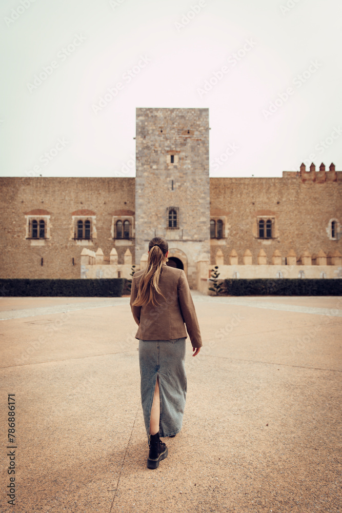 Girl walking towards the castle of the kings of Mallorca in Perpignan